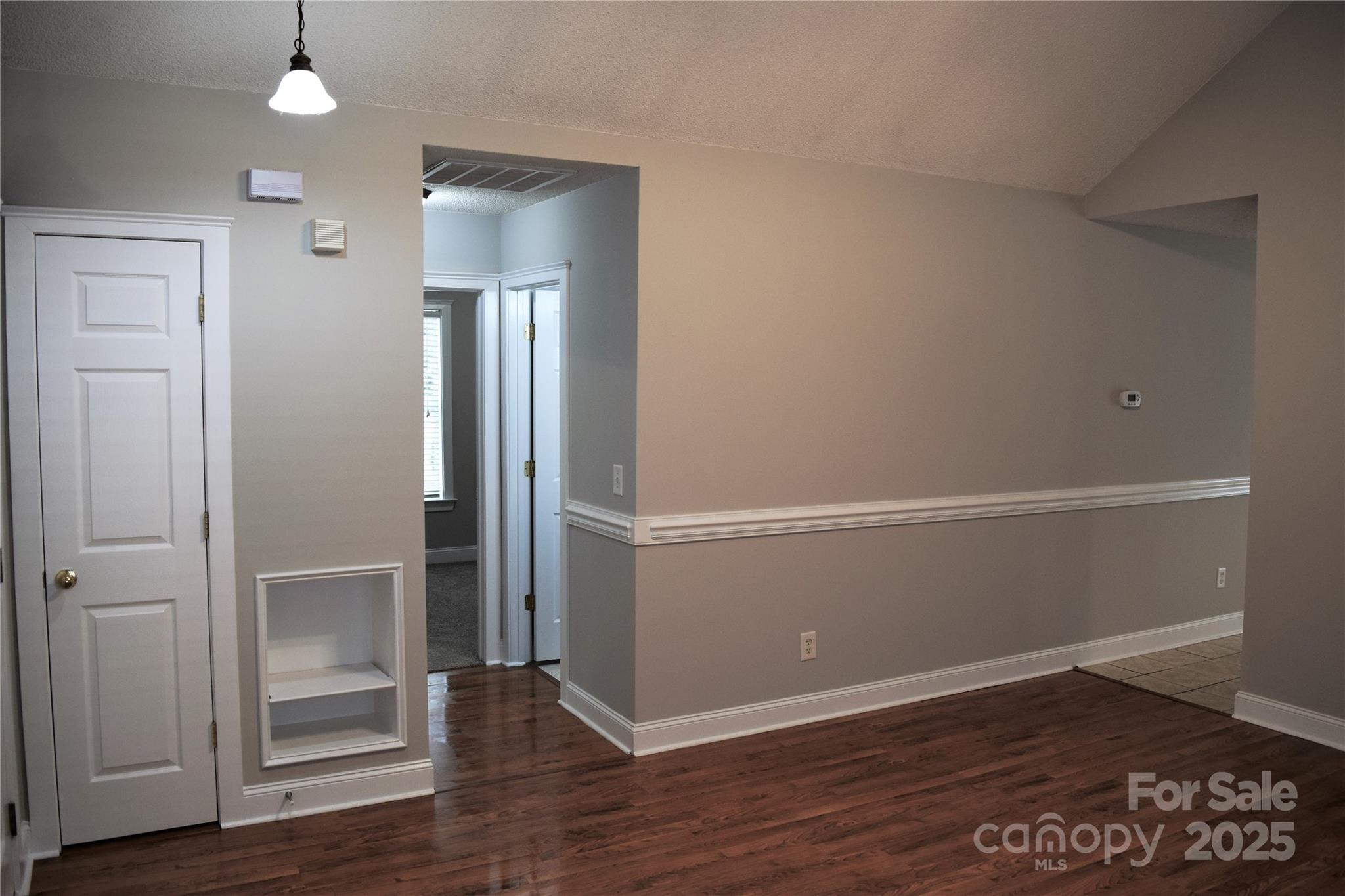 13840 Hastings Farm Road Huntersville, NC 28078 - Photo 7 of 32 an empty room with wooden floor cabinet and ceiling fan