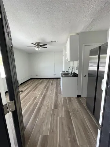 a view of a kitchen from a hallway