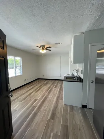 a kitchen with granite countertop a stove and a refrigerator