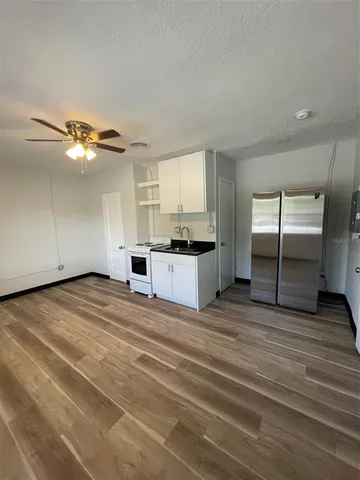 a view of a kitchen with a sink cabinets and a window