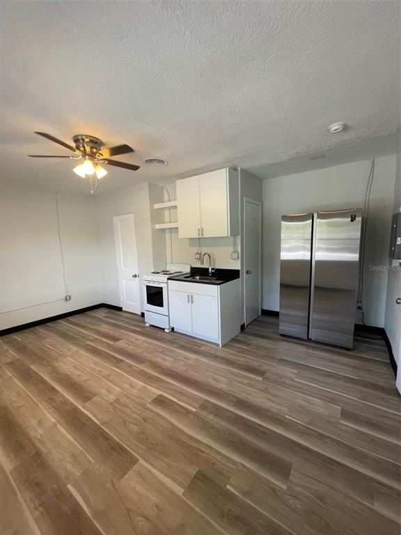 707 Rosery Road Northwest, Unit 3 Largo, FL 33770 - Photo 5 of 10 a view of a kitchen with a sink cabinets and a window