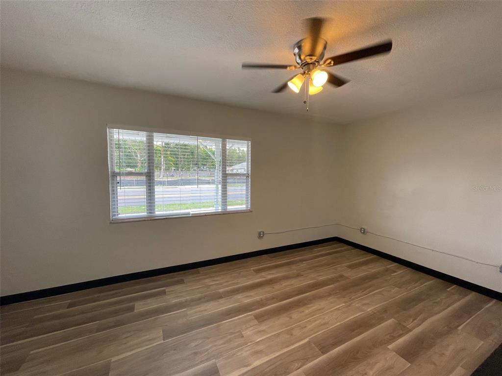 707 Rosery Road Northwest, Unit 3 Largo, FL 33770 - Photo 6 of 10 a view of an empty room with wooden floor and a window