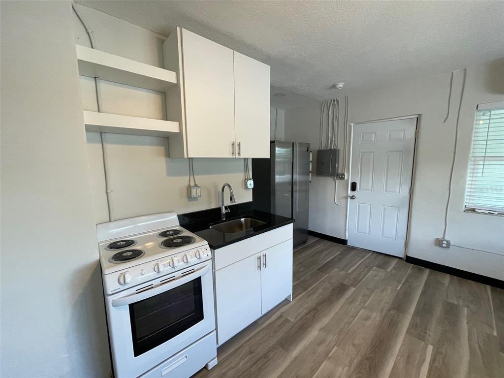707 Rosery Road Northwest, Unit 3 Largo, FL 33770 - Photo 9 of 10 a kitchen with a stove and a microwave