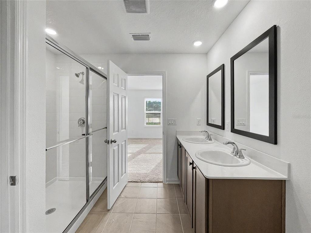 55 Signet Circle Flagler Beach, FL 32136 - Photo 9 of 39 a spacious bathroom with a shower sink and mirror