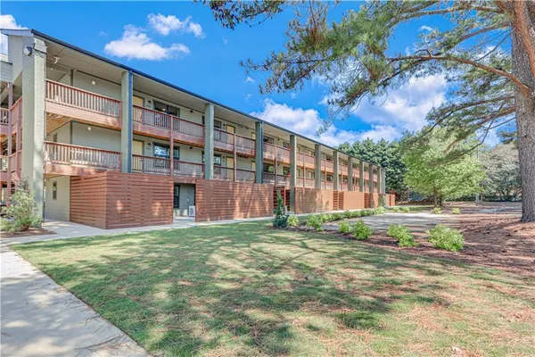 a view of a building with a yard