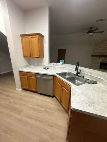 a kitchen with a sink and a stove top oven