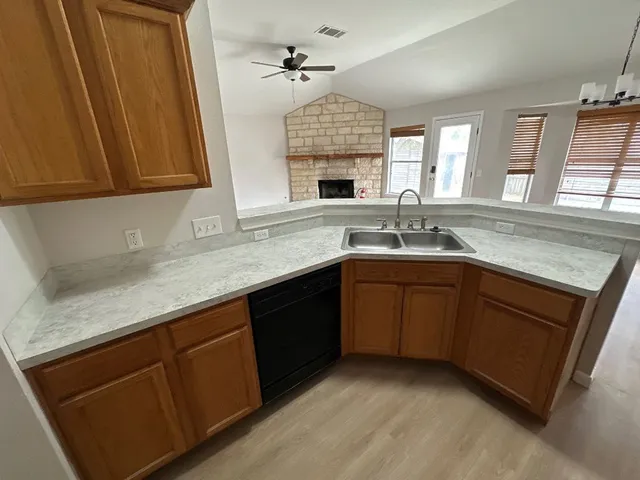 a kitchen with granite countertop a sink and cabinets