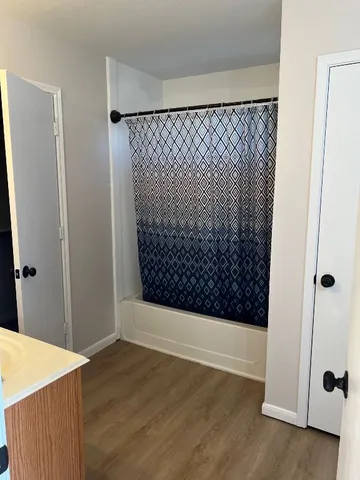 a view of walk in closet with wooden floor