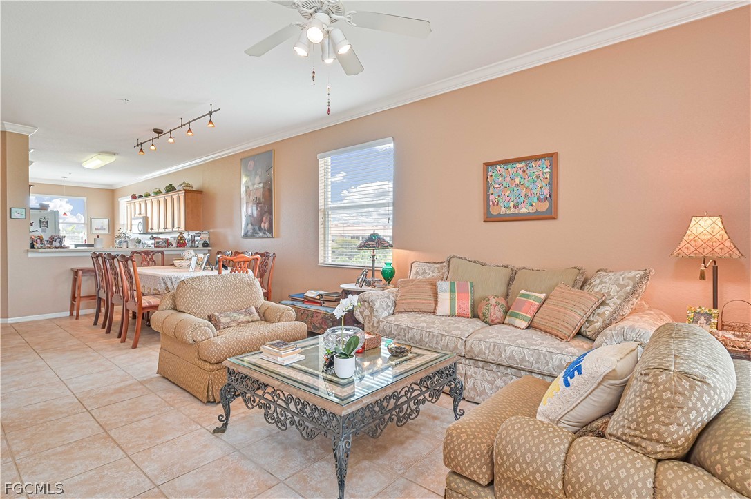 8251 Pathfinder Loop, Unit 641 Fort Myers, FL 33919 - Photo 11 of 37 a living room with furniture a dining table and a chandelier