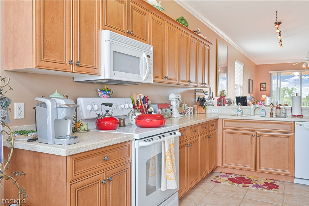 8251 Pathfinder Loop, Unit 641 Fort Myers, FL 33919 - Photo 16 of 37 a kitchen with kitchen island granite countertop counter top space appliances and a sink