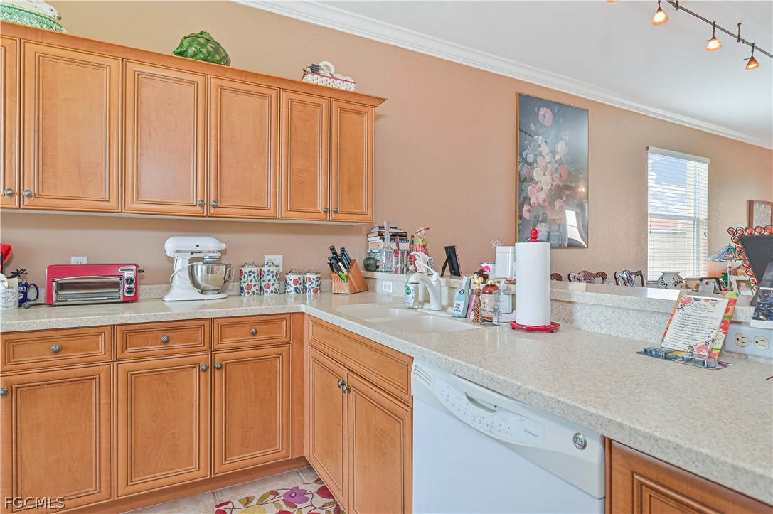 8251 Pathfinder Loop, Unit 641 Fort Myers, FL 33919 - Photo 18 of 37 a kitchen with white cabinets and sink