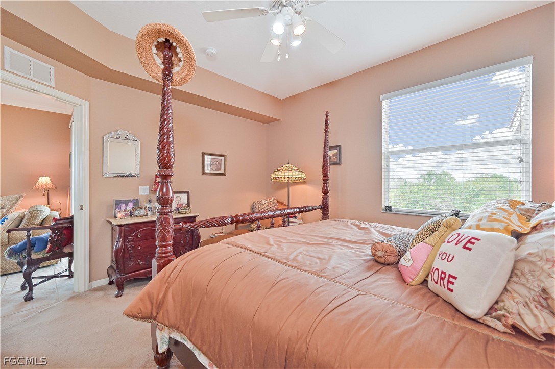 8251 Pathfinder Loop, Unit 641 Fort Myers, FL 33919 - Photo 22 of 37 a bedroom with a bed and a chandelier