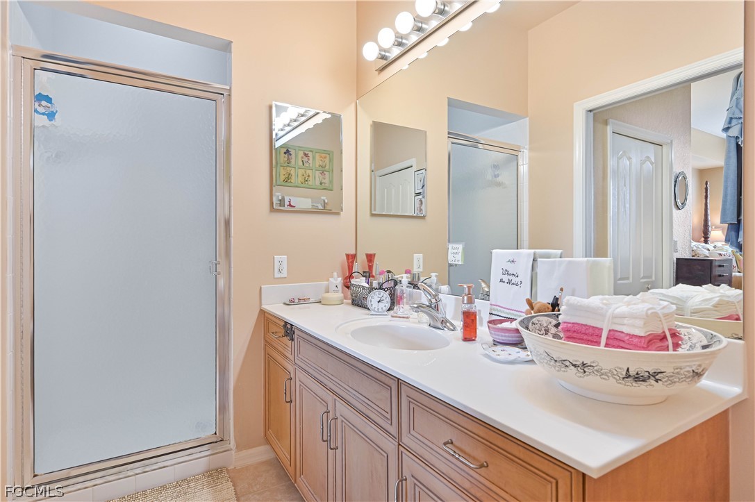 8251 Pathfinder Loop, Unit 641 Fort Myers, FL 33919 - Photo 23 of 37 a bathroom with a sink vanity and mirror