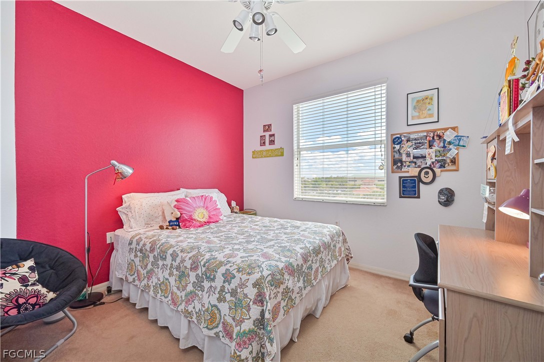 8251 Pathfinder Loop, Unit 641 Fort Myers, FL 33919 - Photo 24 of 37 a bedroom with a bed and a table in it