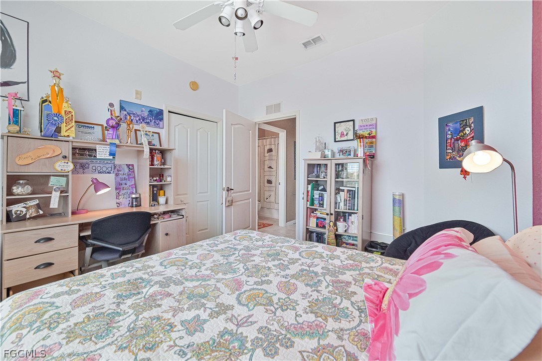 8251 Pathfinder Loop, Unit 641 Fort Myers, FL 33919 - Photo 25 of 37 a bedroom with a bed cabinets and window