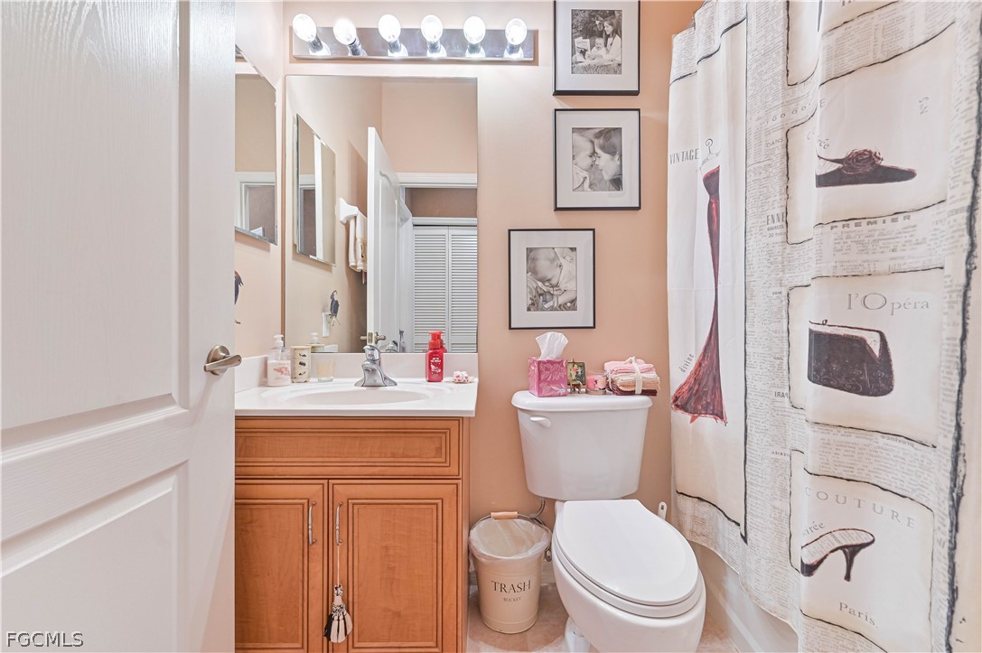 8251 Pathfinder Loop, Unit 641 Fort Myers, FL 33919 - Photo 26 of 37 a bathroom with a granite countertop toilet sink and mirror