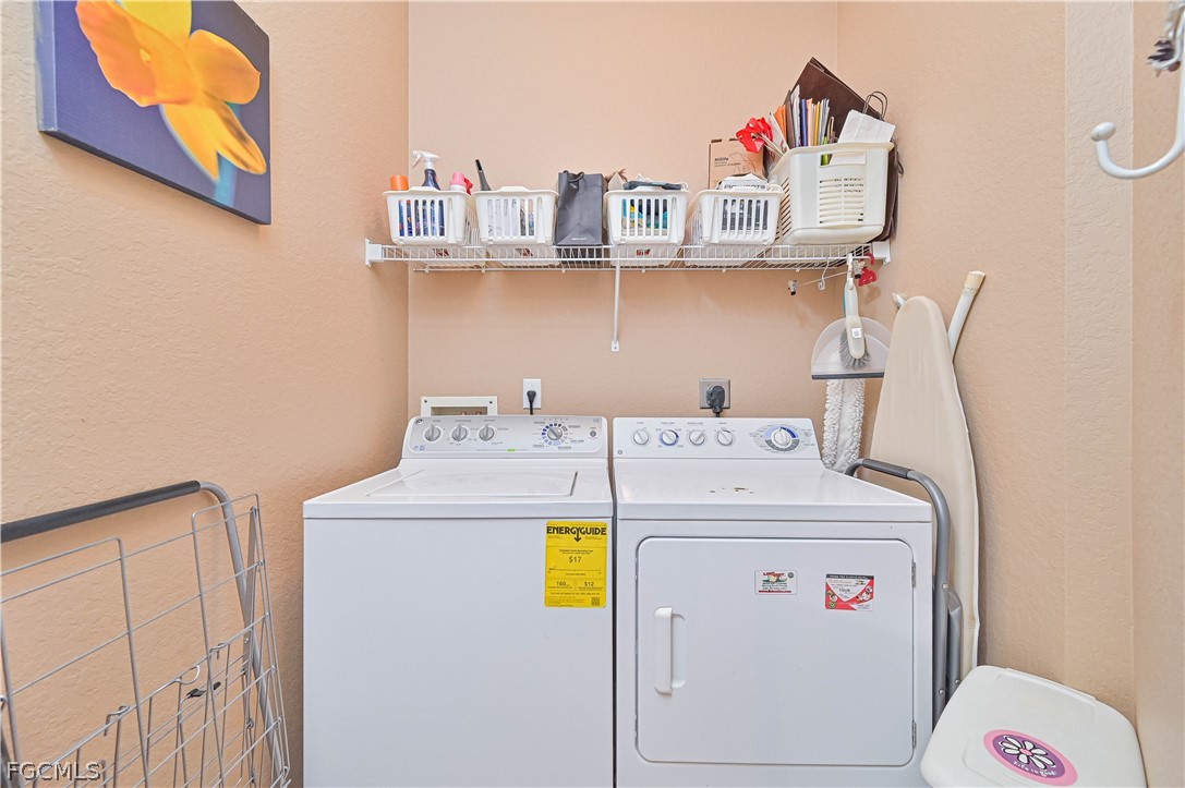 8251 Pathfinder Loop, Unit 641 Fort Myers, FL 33919 - Photo 27 of 37 a utility room with dryer and washer