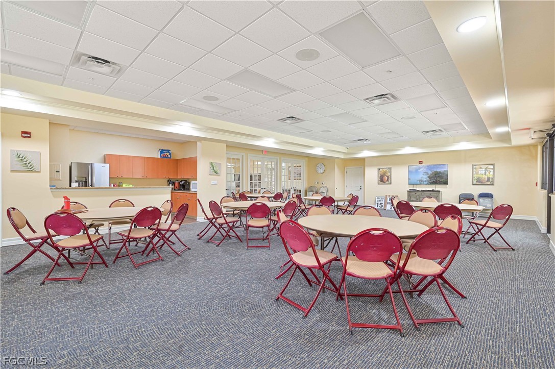 8251 Pathfinder Loop, Unit 641 Fort Myers, FL 33919 - Photo 30 of 37 a room with lots of chairs a chandelier and pool table