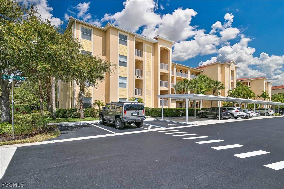 8251 Pathfinder Loop, Unit 641 Fort Myers, FL 33919 - Photo 4 of 37 a view of a parked cars in front of a building