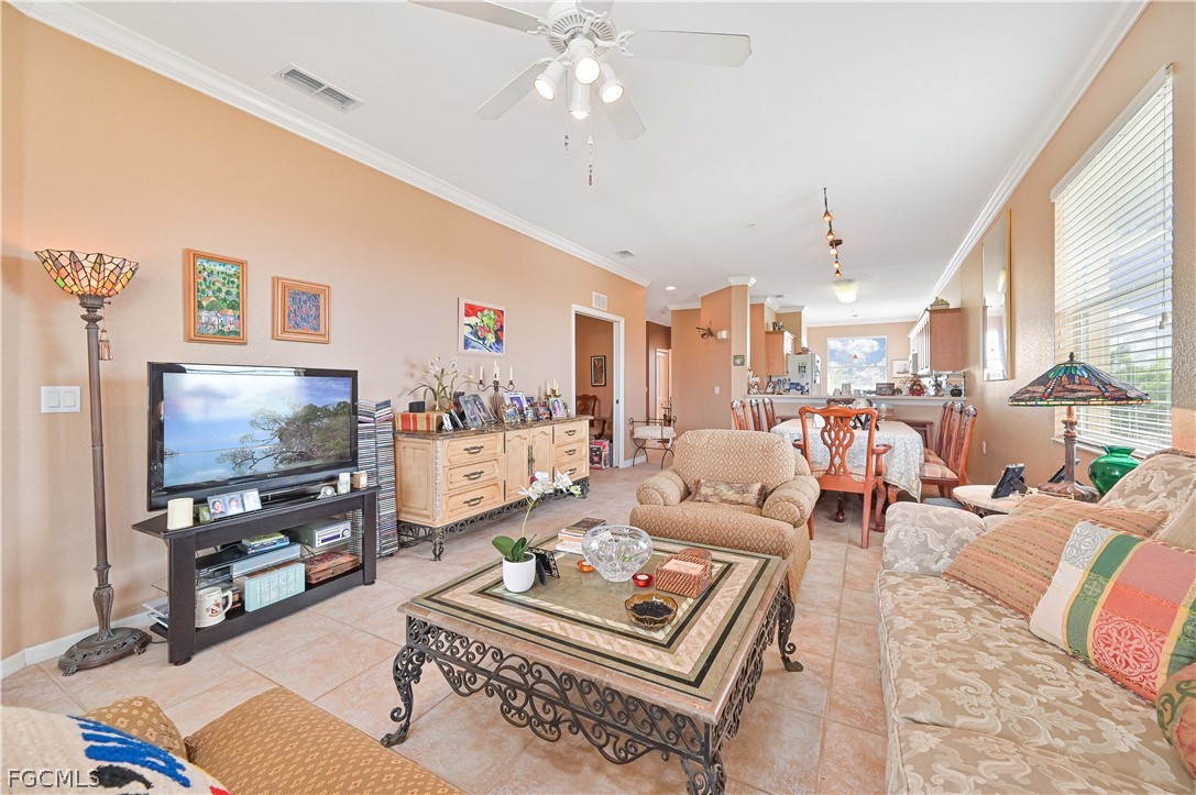 8251 Pathfinder Loop, Unit 641 Fort Myers, FL 33919 - Photo 10 of 37 a living room with furniture a flat screen tv and a large window