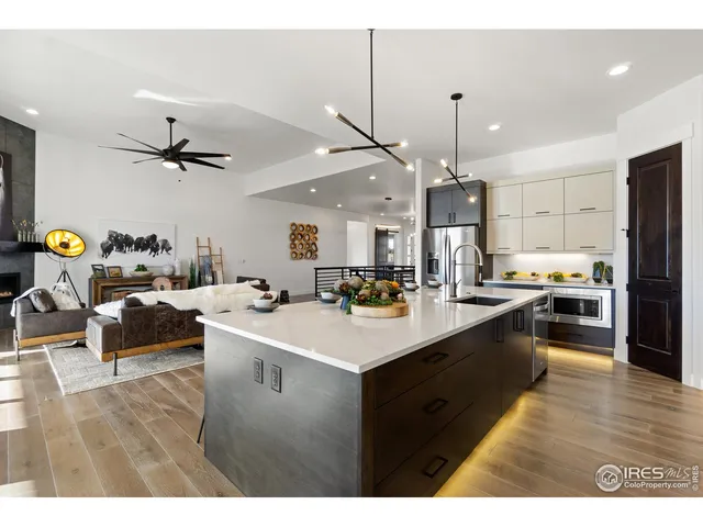 a kitchen with stainless steel appliances a stove a sink dishwasher and a refrigerator