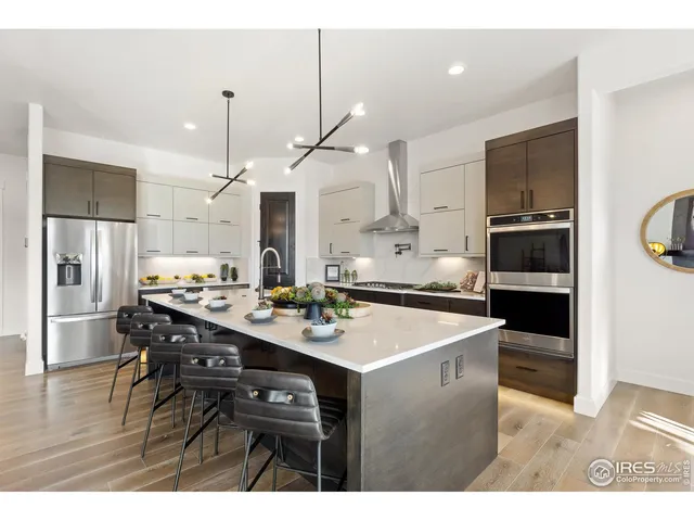 a kitchen with a table chairs refrigerator and microwave