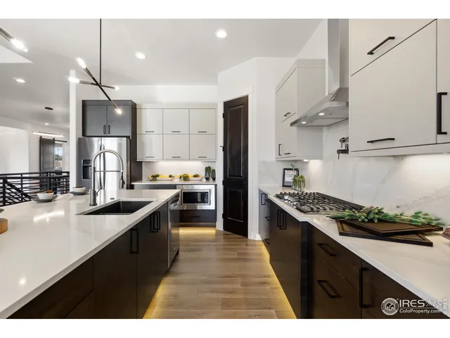 a kitchen with stainless steel appliances kitchen island a sink stove and refrigerator