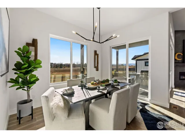 a dining room with furniture window and wooden floor