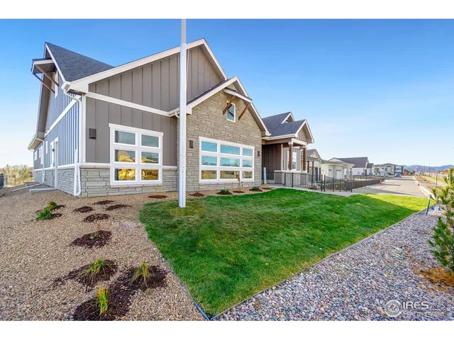a view of a back yard of the house with a yard