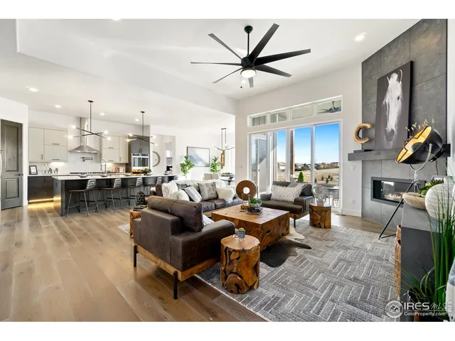 a living room with furniture and kitchen view