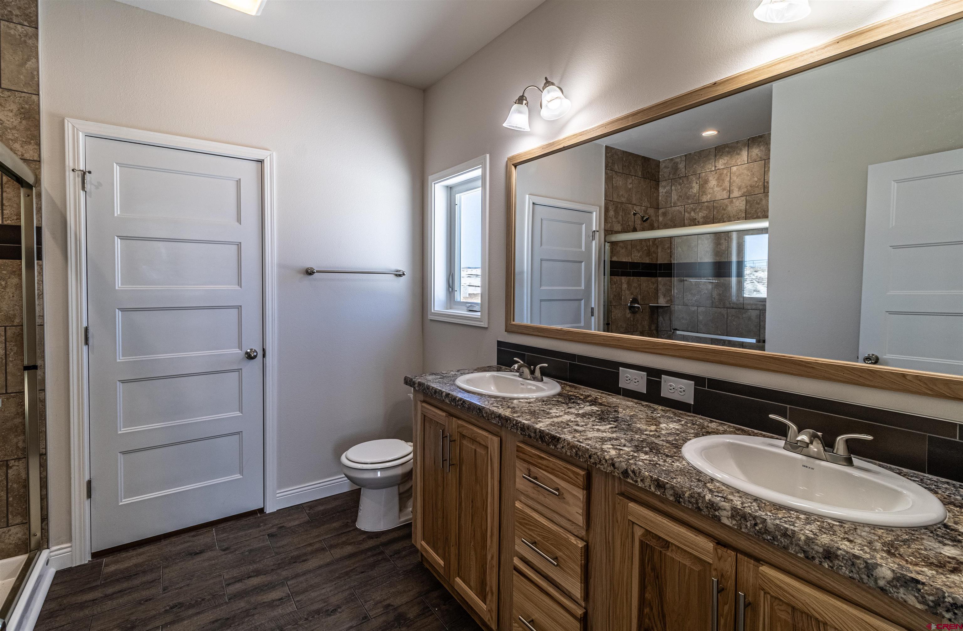 200 Chesterfield Place Ignacio, CO 81137 - Photo 17 of 35 a bathroom with a granite countertop double vanity sink and a mirror