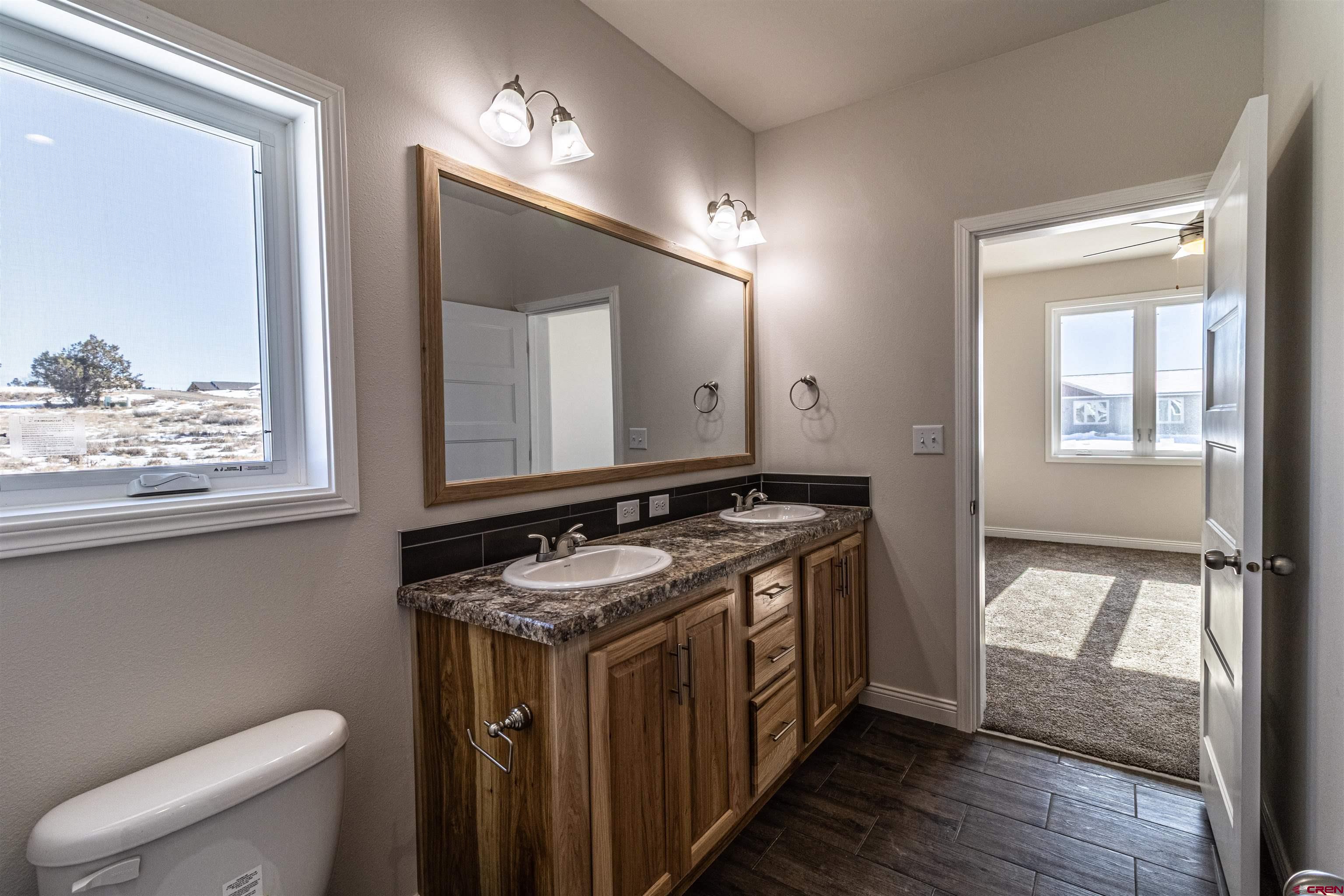 200 Chesterfield Place Ignacio, CO 81137 - Photo 20 of 35 a bathroom with a toilet a sink and a mirror