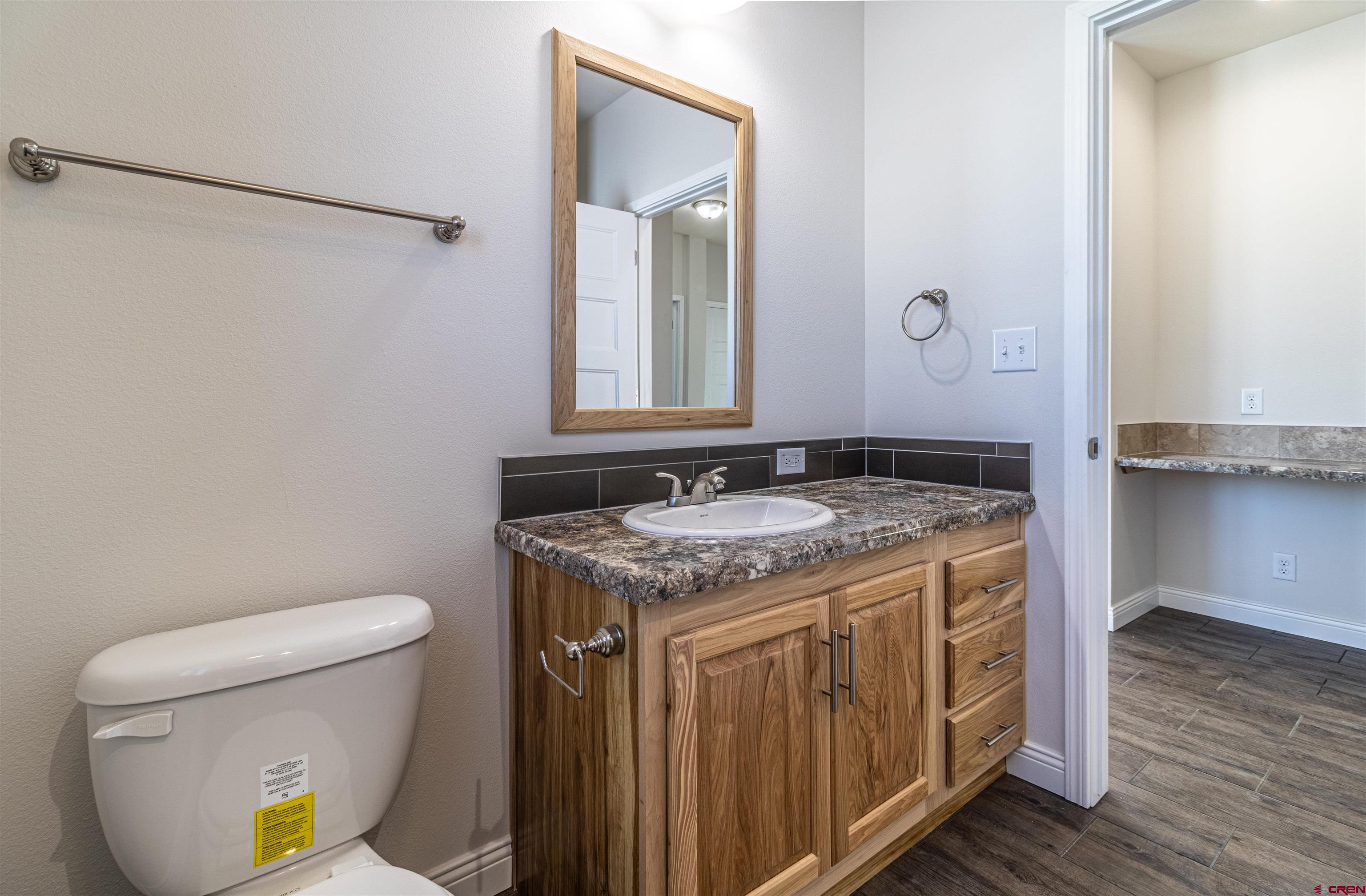 200 Chesterfield Place Ignacio, CO 81137 - Photo 23 of 35 a bathroom with a granite countertop sink and a toilet