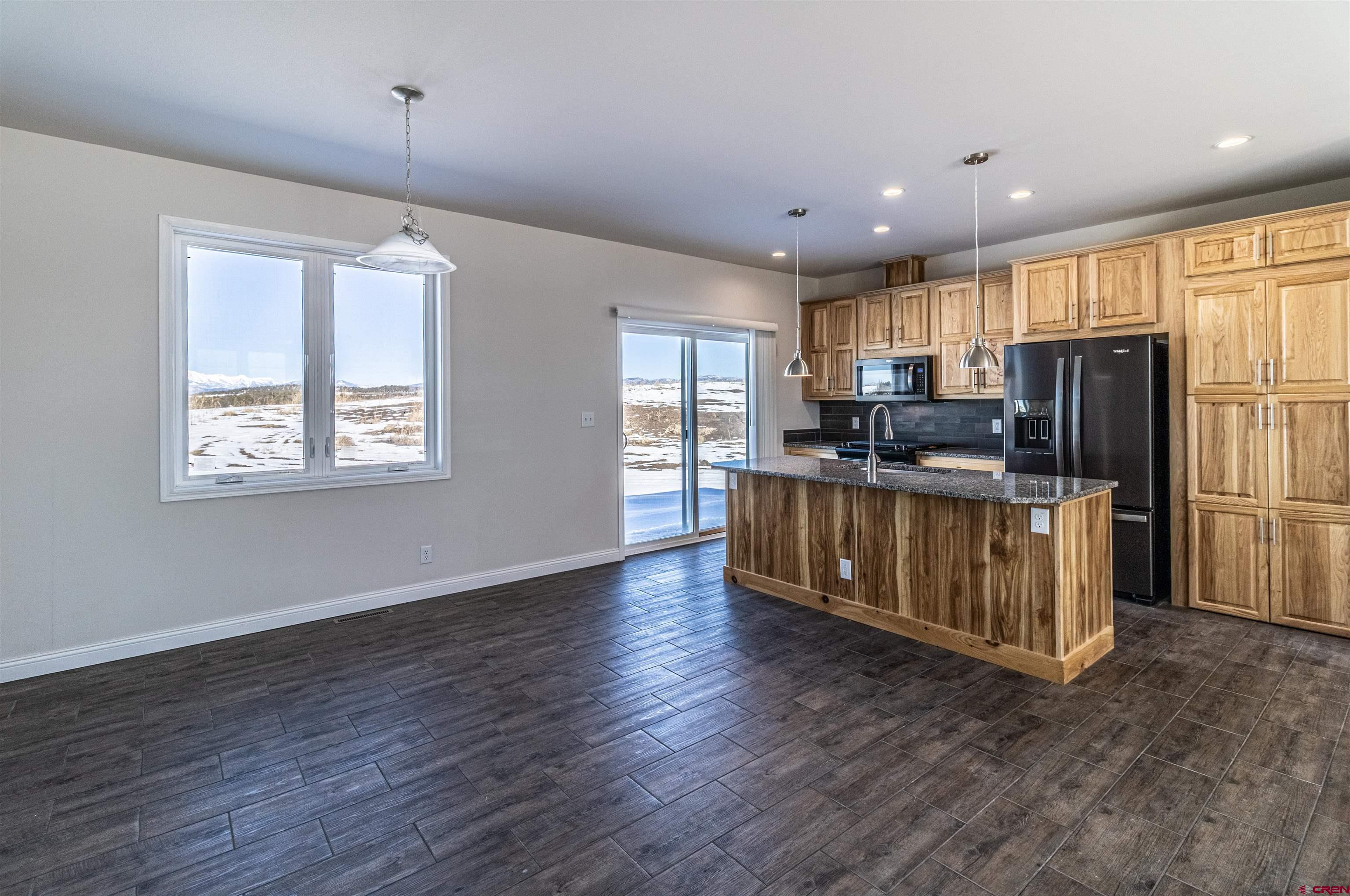 200 Chesterfield Place Ignacio, CO 81137 - Photo 7 of 35 a kitchen with stainless steel appliances granite countertop a refrigerator a stove a sink and a microwave