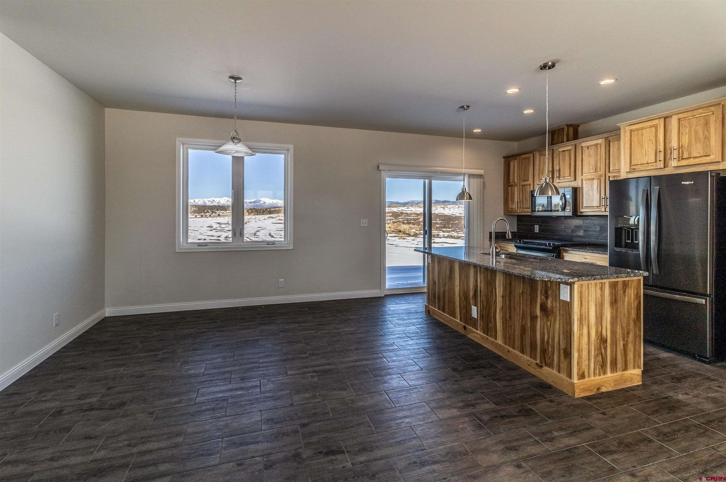200 Chesterfield Place Ignacio, CO 81137 - Photo 8 of 35 a kitchen with stainless steel appliances a refrigerator and a stove top oven
