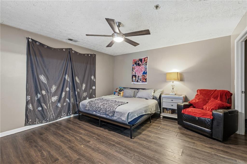 6203 Fairington Ridge Circle Stonecrest, GA 30038 - Photo 11 of 13 a bedroom with a bed couch and a window