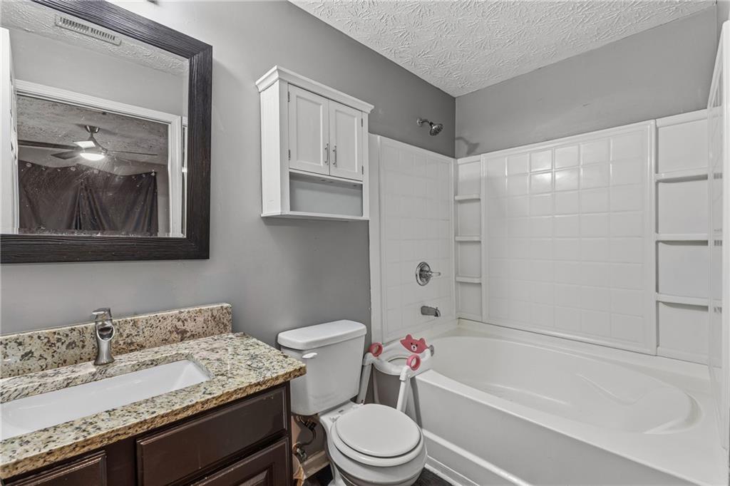 6203 Fairington Ridge Circle Stonecrest, GA 30038 - Photo 12 of 13 a bathroom with a sink a toilet and a bathtub