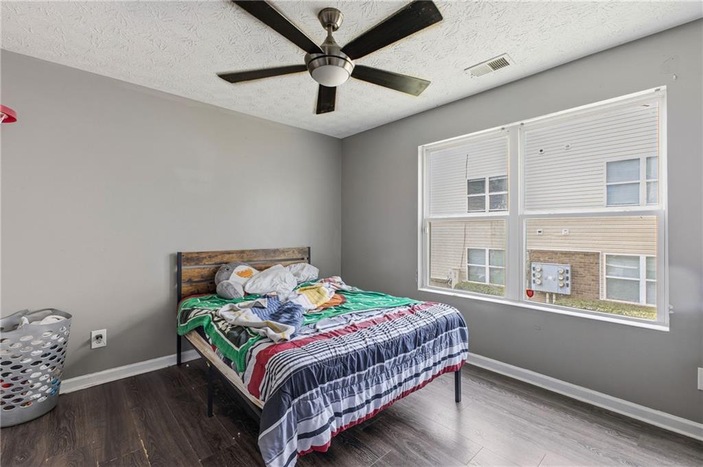 6203 Fairington Ridge Circle Stonecrest, GA 30038 - Photo 8 of 13 a bedroom with a bed and a window