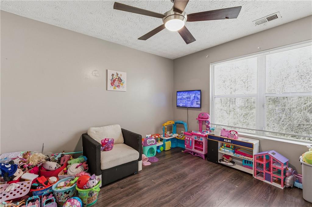 6203 Fairington Ridge Circle Stonecrest, GA 30038 - Photo 10 of 13 a living room with baby toys