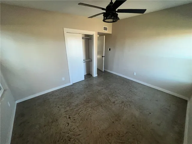 an empty room with a empty space and a ceiling fan