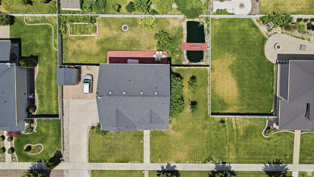 592 West 650 South Springville, UT 84663 - Photo 4 of 33 Property featuring a dark shingle roof, a concrete driveway, and a gravel parking area