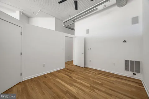 a view of a room with wooden floor