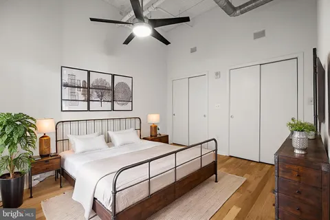 a bedroom with a large bed and a chandelier
