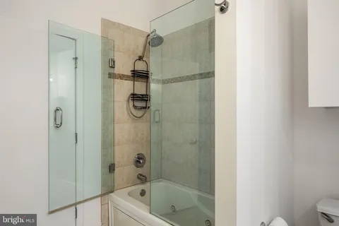 a bathroom with a shower and a toilet