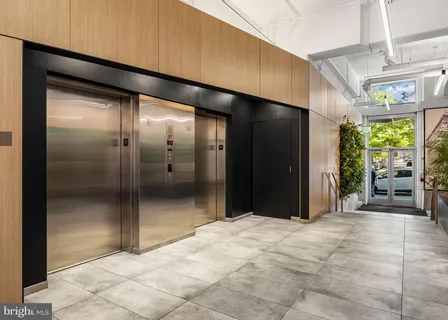 a view of a porch with chairs and potted plants