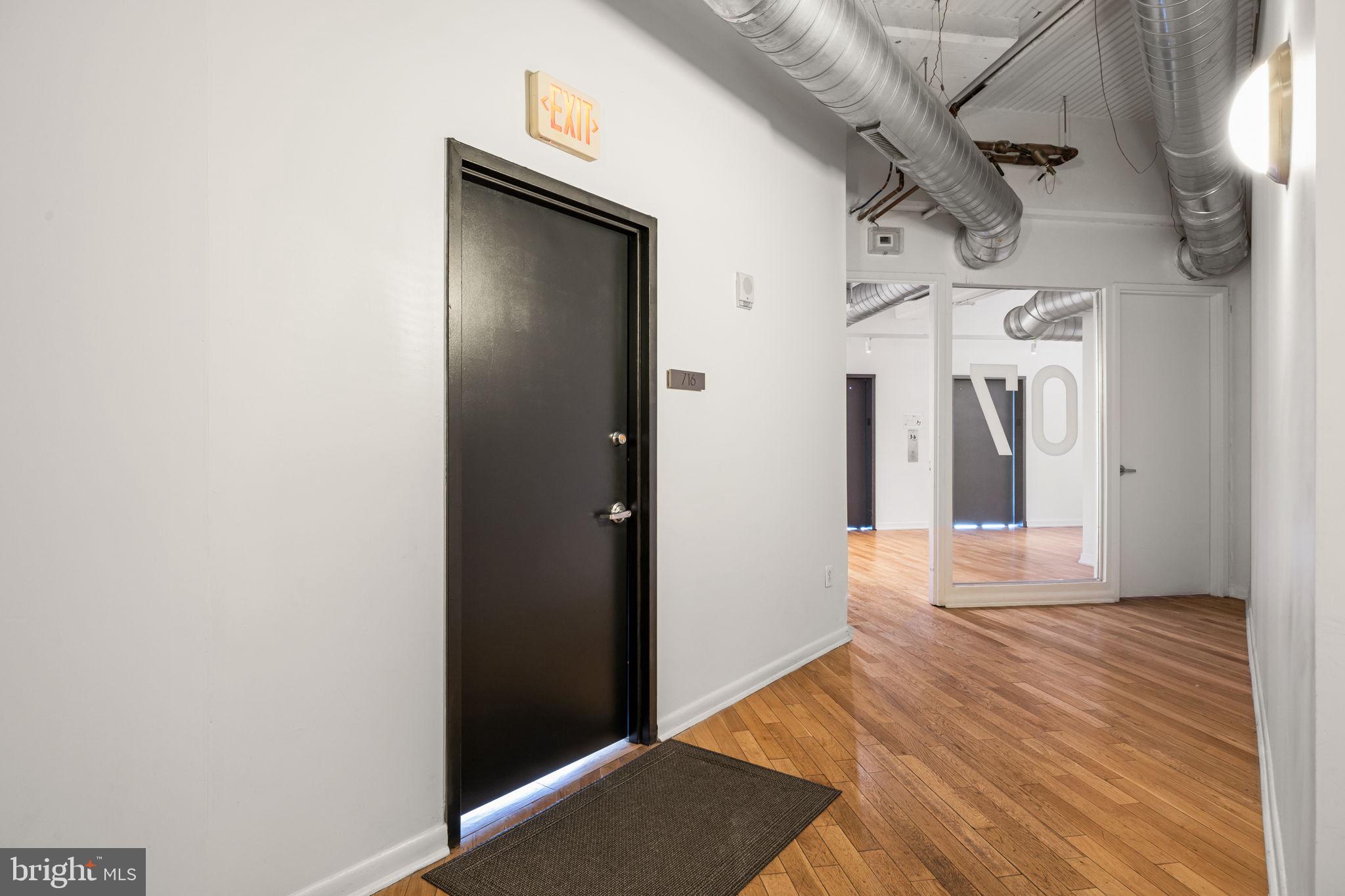2200-28 Arch Street, Unit 716 Philadelphia, PA 19103 - Photo 27 of 35 a view of a hallway with wooden floor