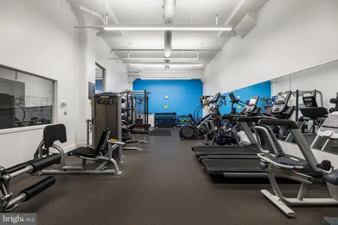 a view of balcony with a couple of cars parked in front of it