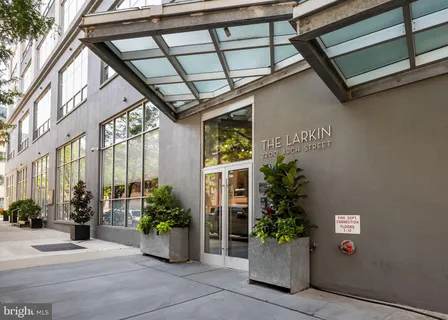 a front view of a house with a potted plant