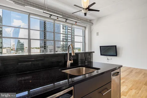 a kitchen with a sink and a stove top oven