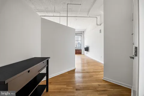 a view of hallway with wooden floor